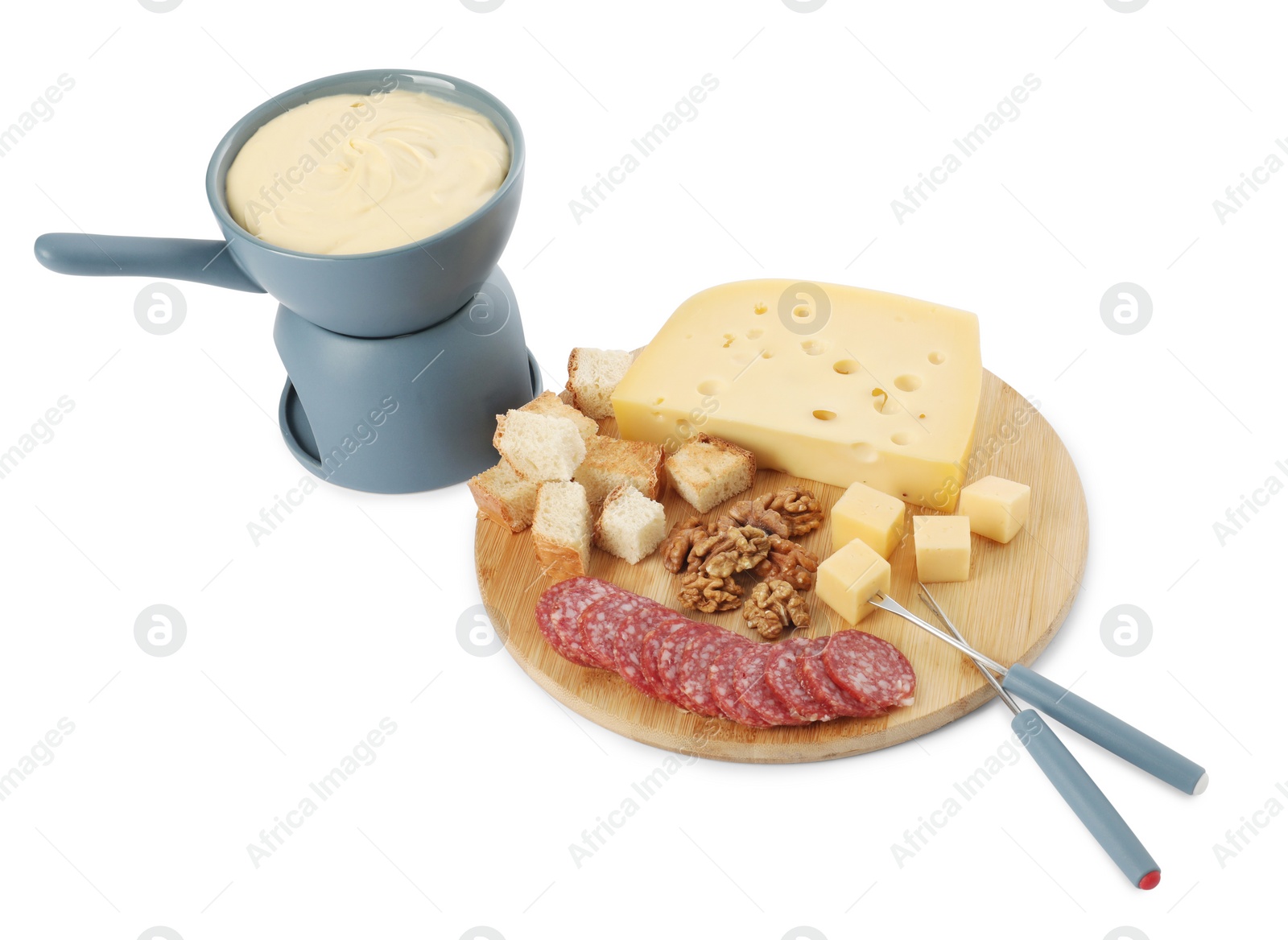 Photo of Fondue with tasty melted cheese, forks and different snacks isolated on white