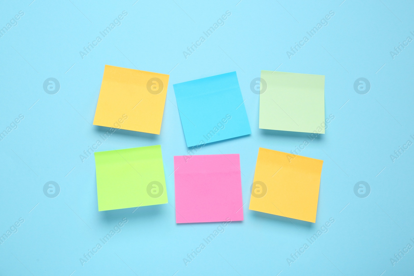 Photo of Blank colorful sticky notes on turquoise background, flat lay. Space for text