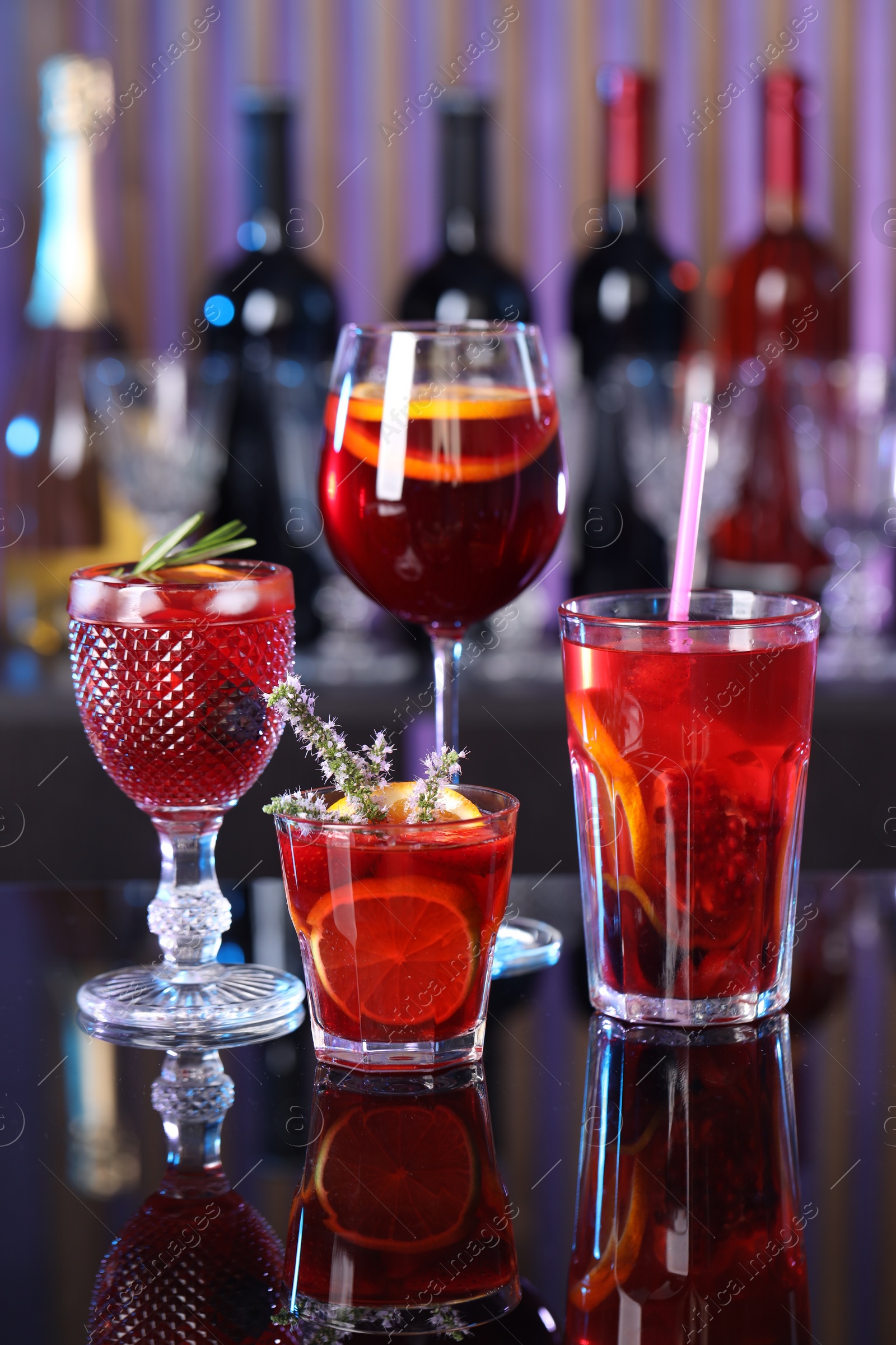Photo of Many glasses of delicious refreshing sangria on counter in bar