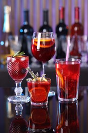 Photo of Many glasses of delicious refreshing sangria on counter in bar