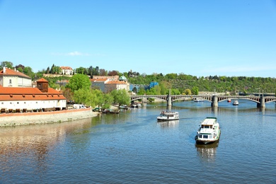 Photo of PRAGUE, CZECH REPUBLIC - APRIL 25, 2019: Cityscape with tourist attractions, Manes Bridge and Vltava river