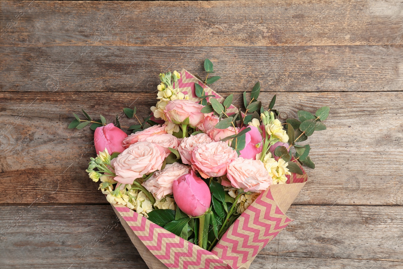 Photo of Bouquet of beautiful fragrant flowers on wooden background