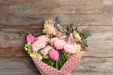 Photo of Bouquet of beautiful fragrant flowers on wooden background