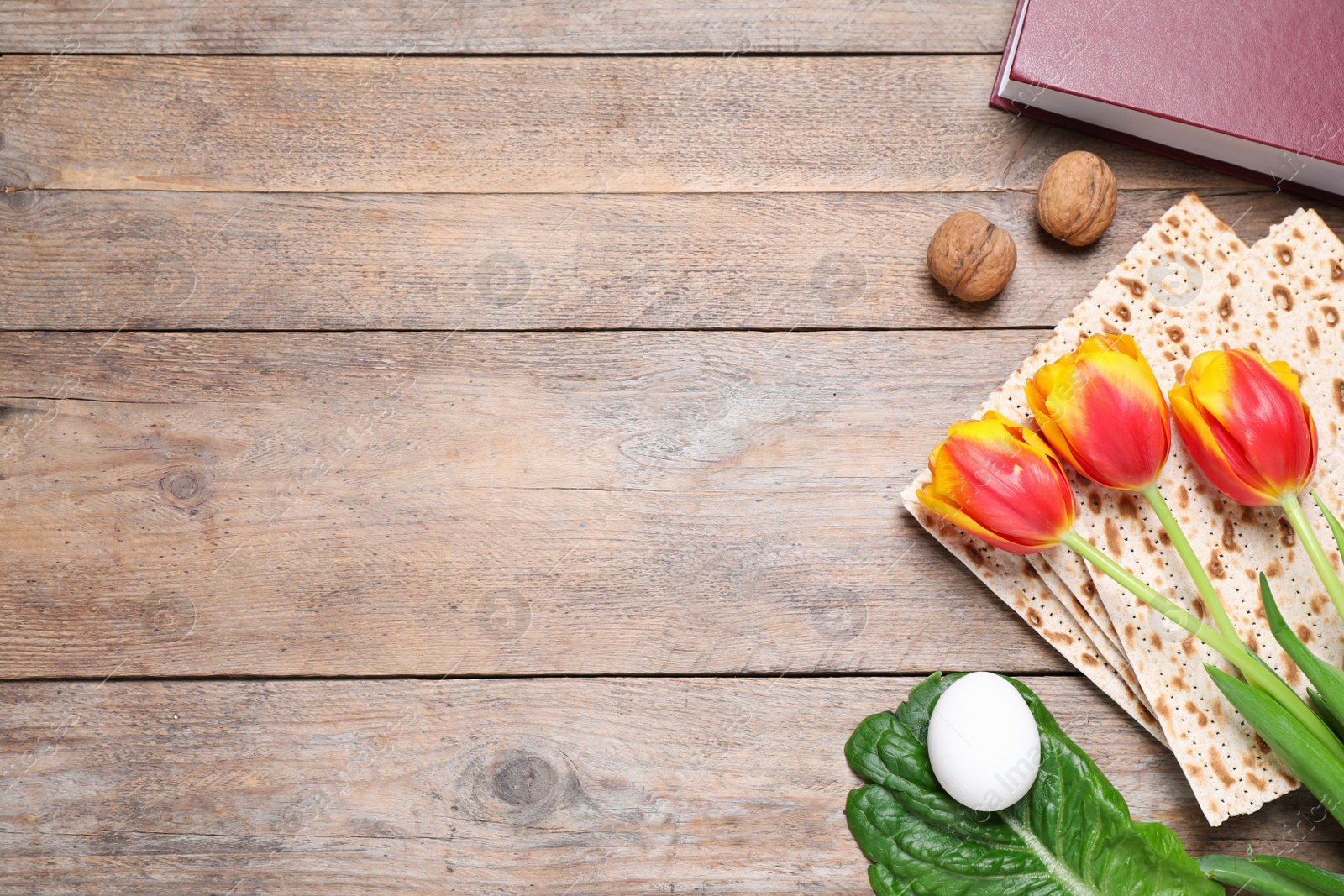 Photo of Flat lay composition with symbolic Pesach (Passover Seder) items on wooden table, space for text