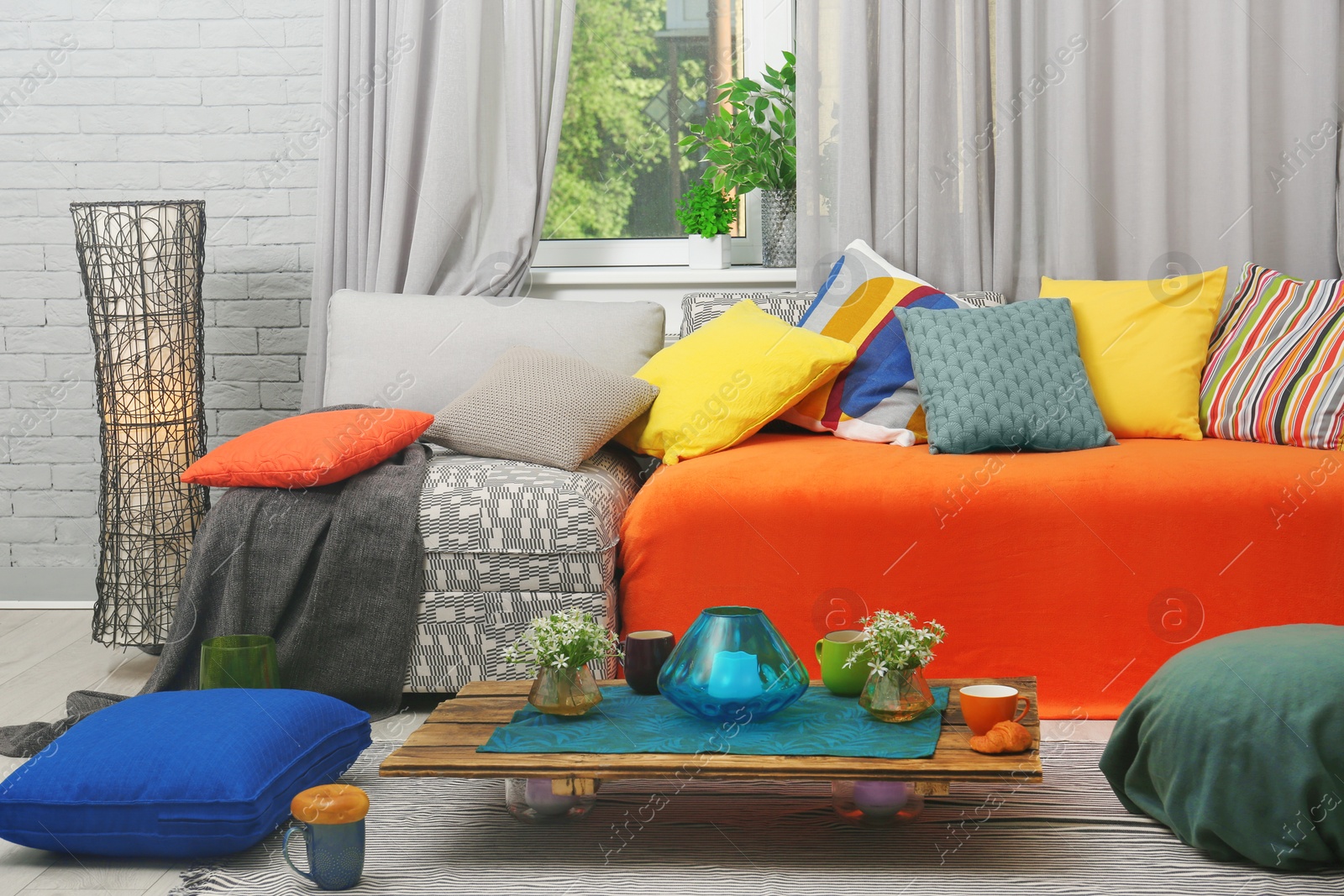 Photo of Creative living room interior with sectional couch and colorful cushions