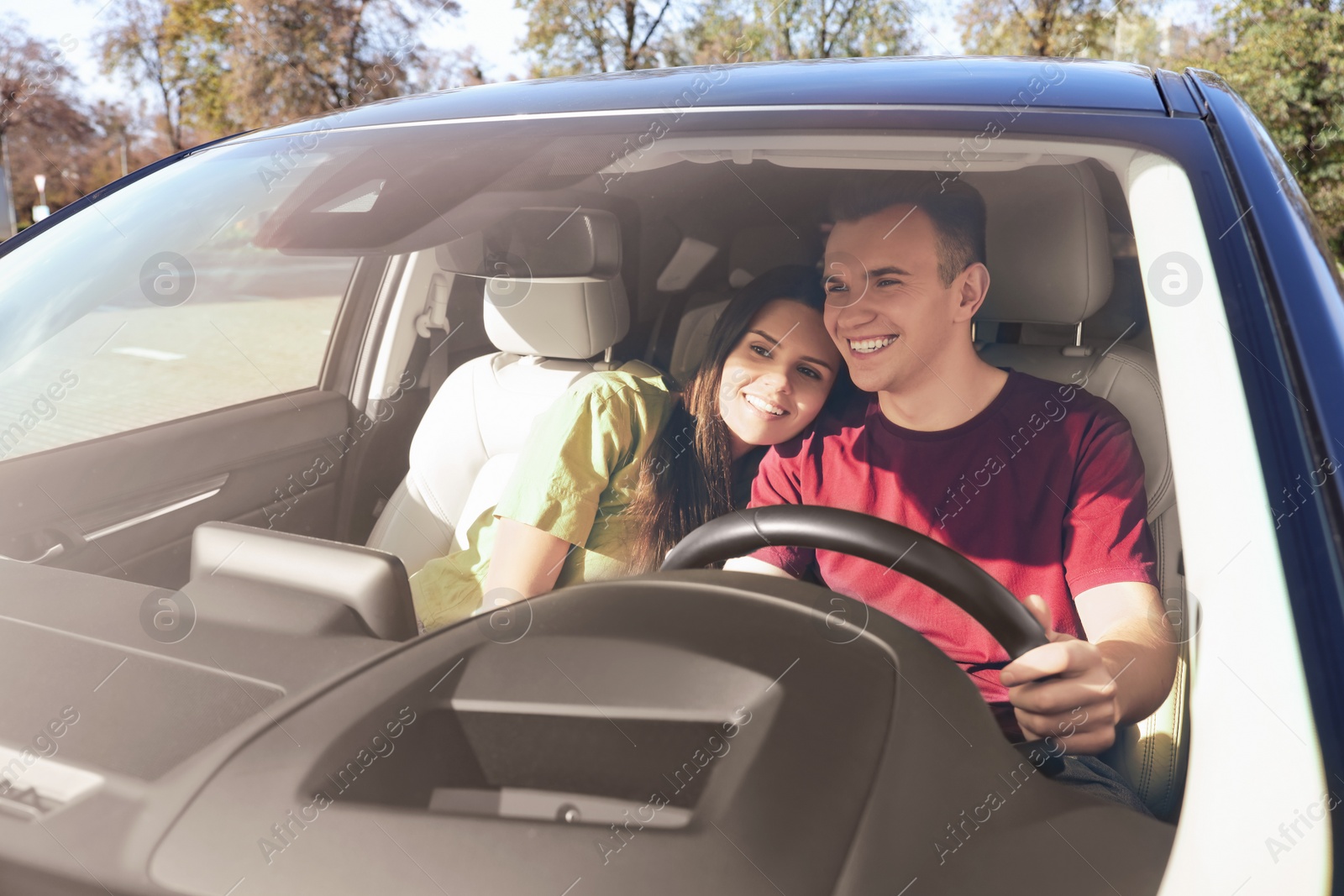 Photo of Happy young couple travelling together by car