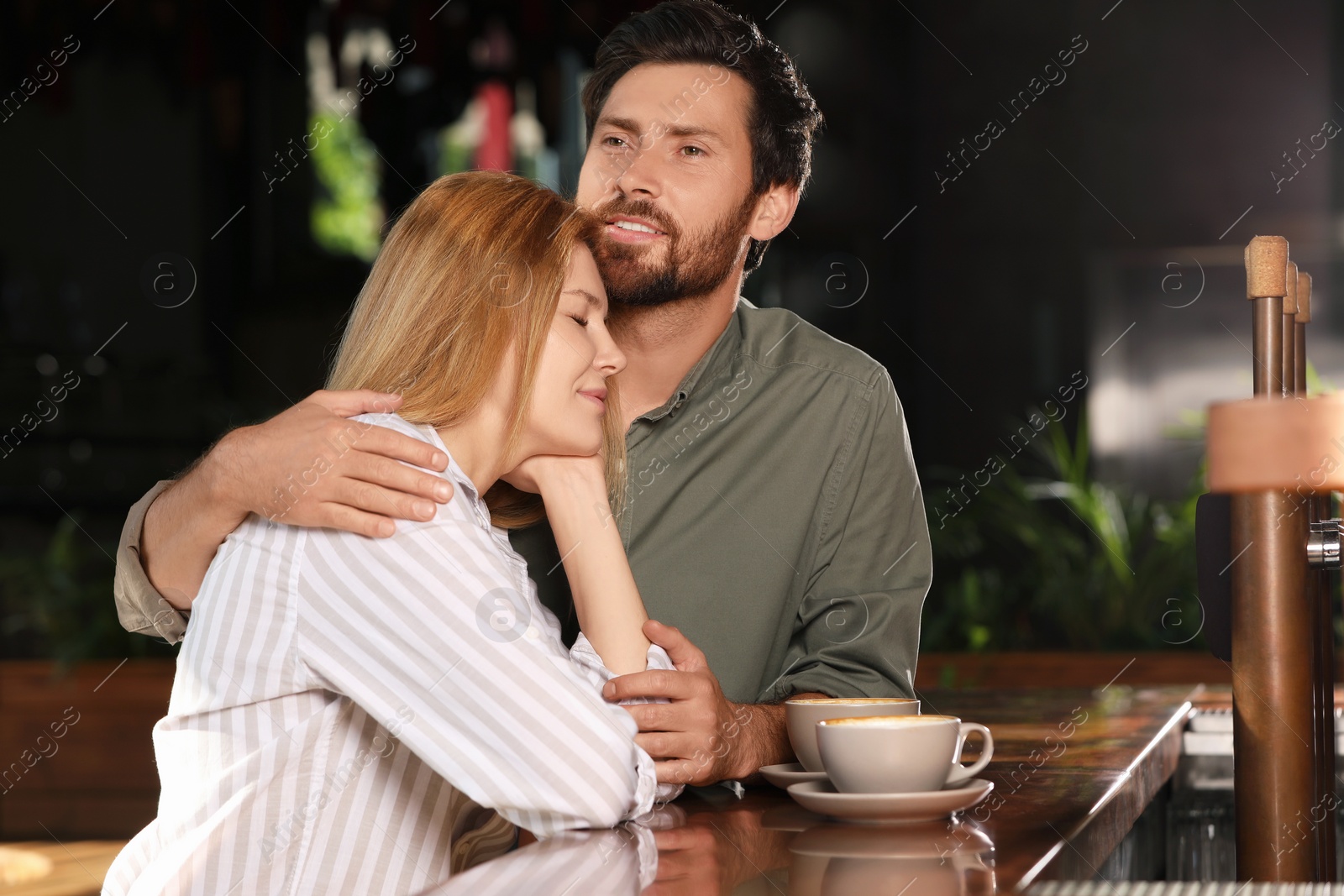 Photo of Romantic date. Lovely couple spending time together in cafe