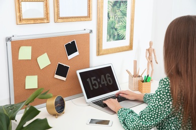 Photo of Woman using computer in home office. Stylish workplace