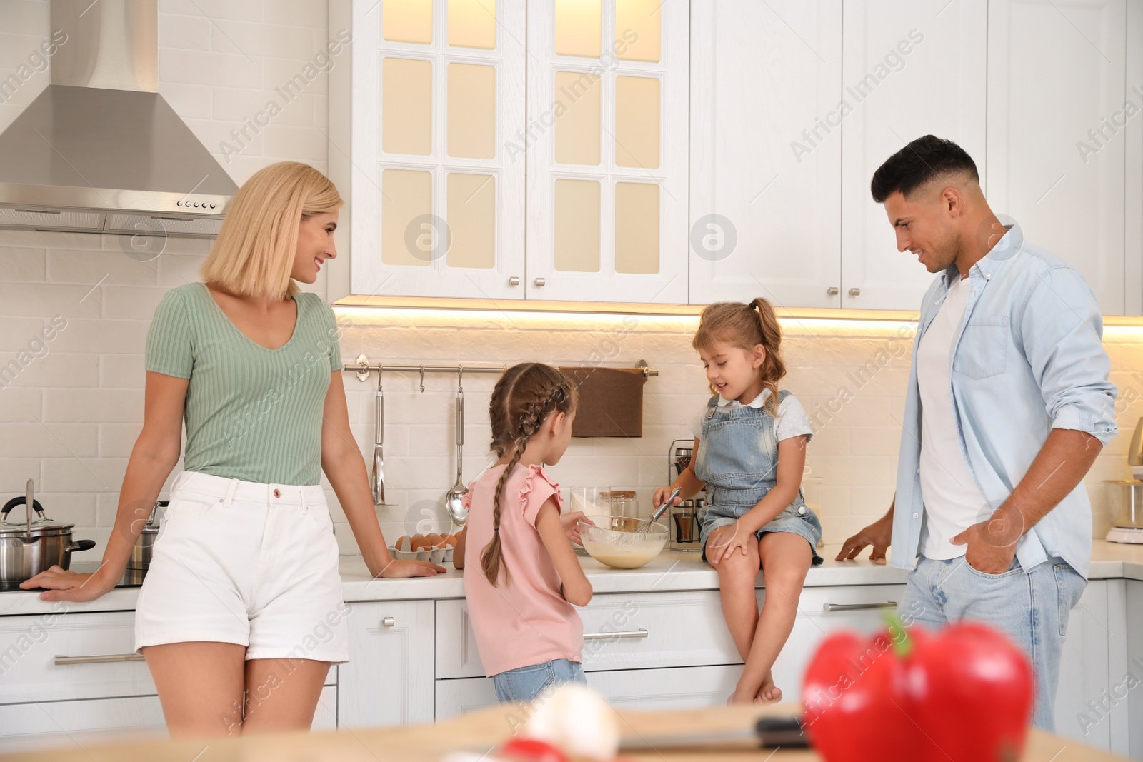 Photo of Happy family cooking together in modern kitchen