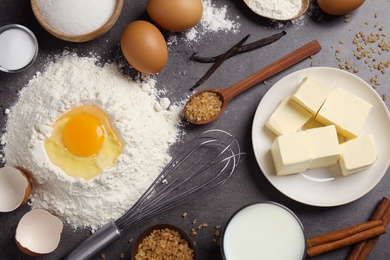 Photo of Flat lay composition with fresh ingredients for delicious homemade cake on grey table