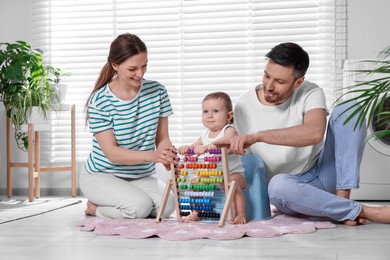 Photo of Parents training their child to sit on baby potty indoors