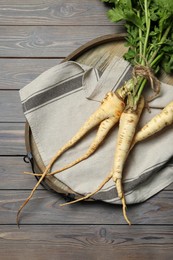 Photo of Tasty fresh ripe parsnips on grey wooden table, top view