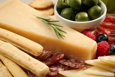 Photo of Snack set with delicious Parmesan cheese, closeup