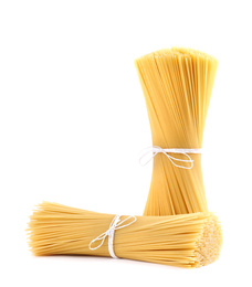 Photo of Tied uncooked Italian spaghetti isolated on white