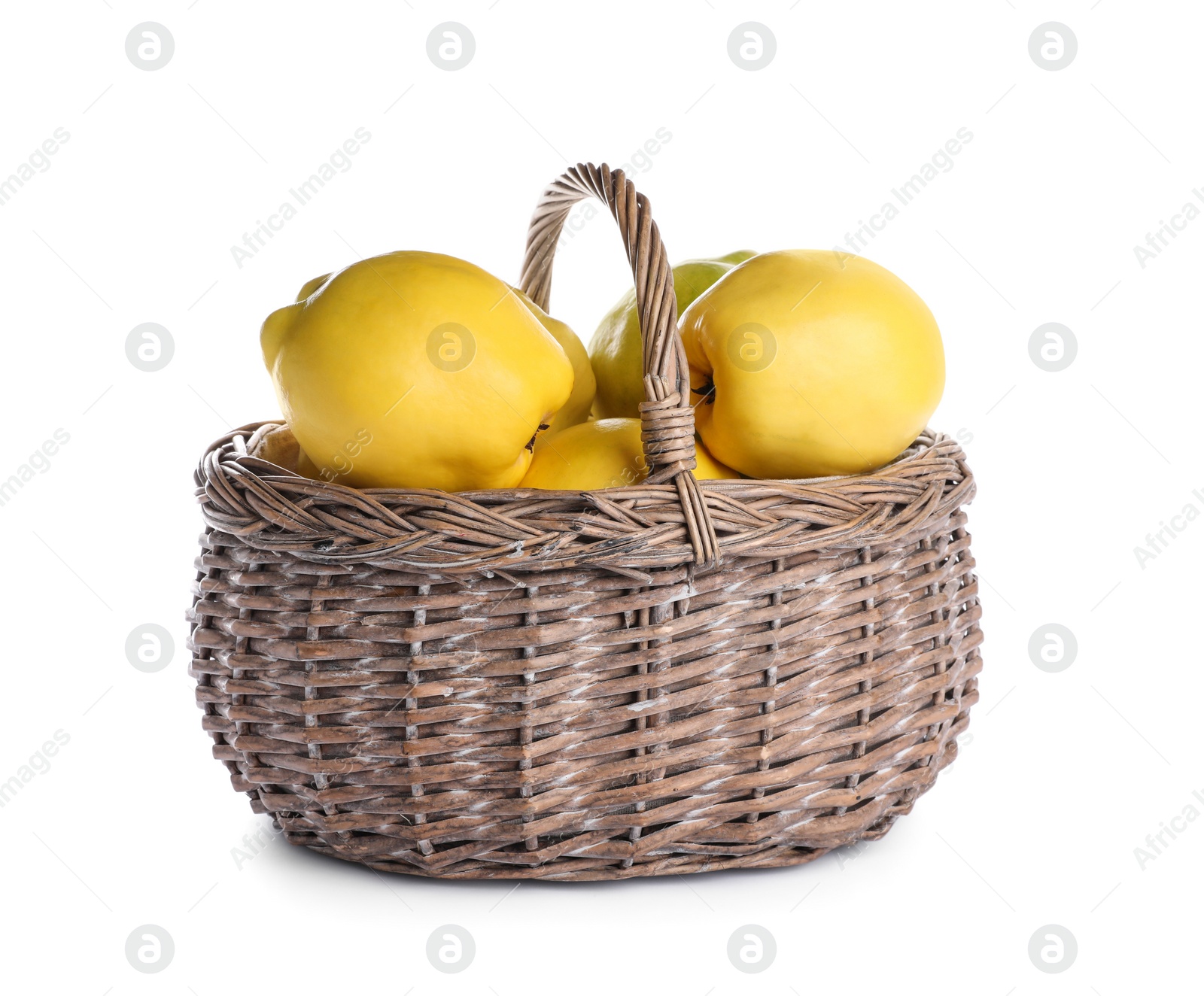 Photo of Ripe quinces in wicker basket on white background