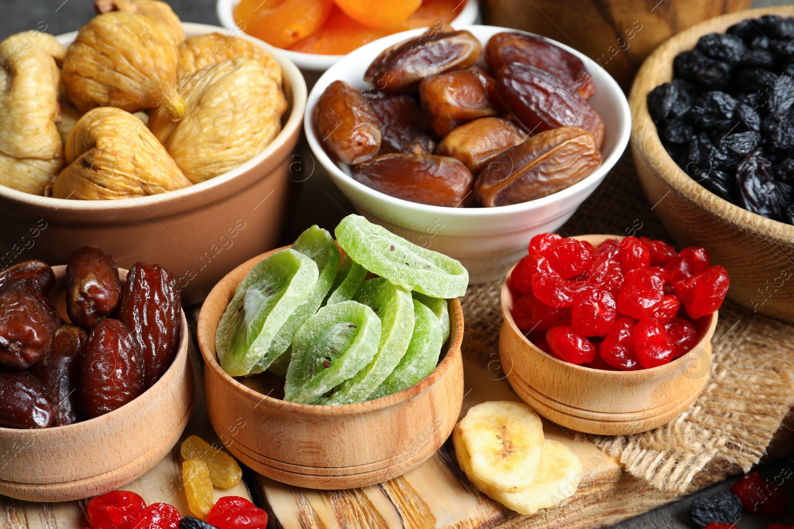 Photo of Bowls with different dried fruits on table. Healthy food