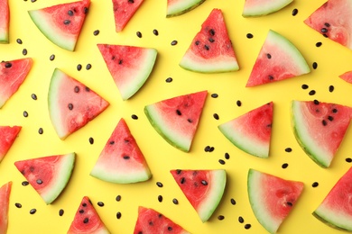 Flat lay composition with slices and seeds of watermelon on color background