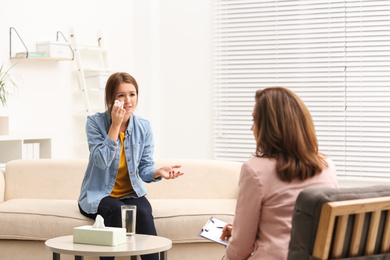 Photo of Psychotherapist working with teenage girl in office