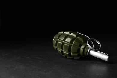 Photo of Hand grenade on black background. Space for text