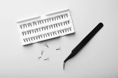 Photo of Set for eyelash extension on grey background, top view