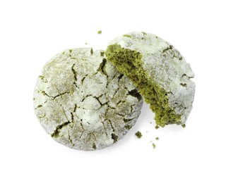 Tasty whole and broken matcha cookies on white background, top view