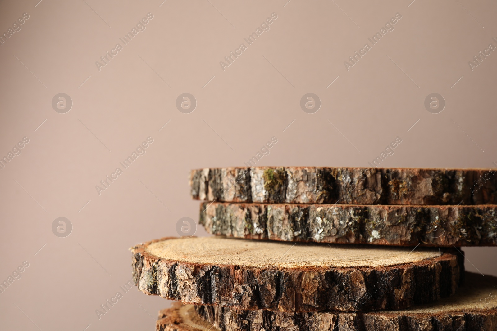 Photo of Presentation for product. Wooden stumps on beige background. Space for text