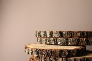 Photo of Presentation for product. Wooden stumps on beige background. Space for text