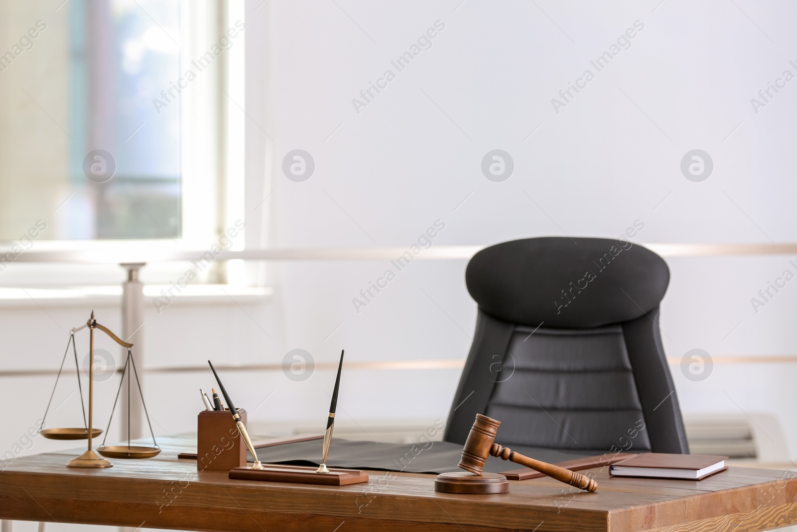 Photo of Table with scales of justice and judge gavel in lawyer's office