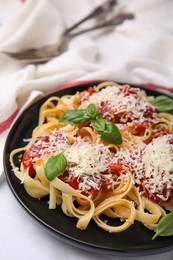 Photo of Delicious pasta with tomato sauce, basil and parmesan cheese on white table, closeup