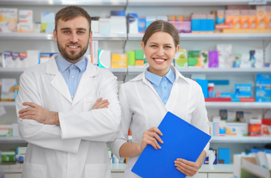 Portrait of professional pharmacists in modern drugstore