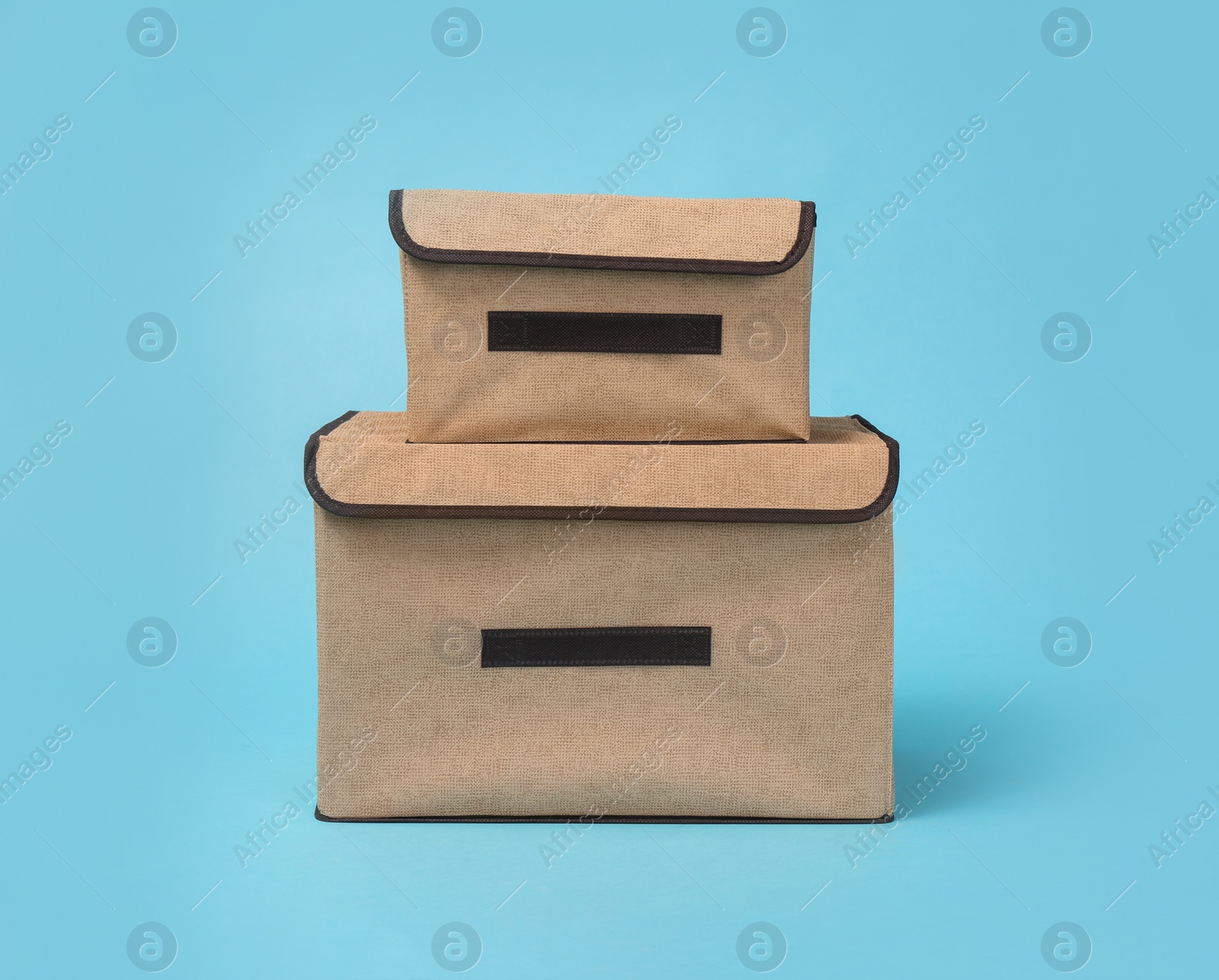 Photo of Two textile storage cases on light blue background