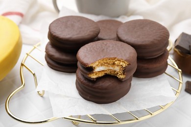 Photo of Tasty banana choco pies on white table, closeup