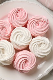 Delicious white and pink marshmallows on plate, top view