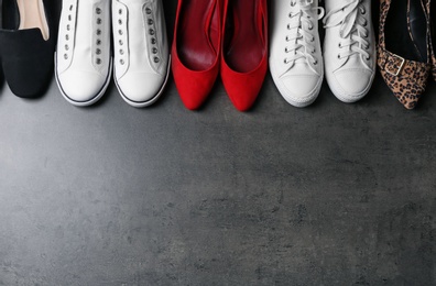 Photo of Flat lay composition with stylish shoes and space for text on grey background