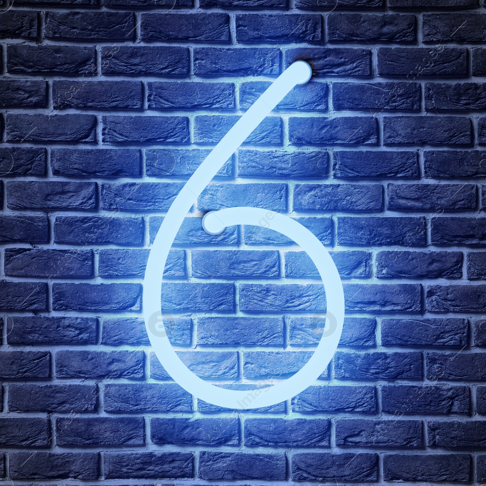 Image of Glowing neon number 6 sign on brick wall