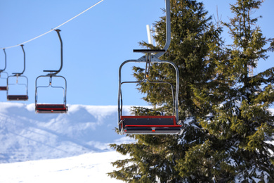 Photo of Empty chairlift at mountain ski resort. Winter vacation