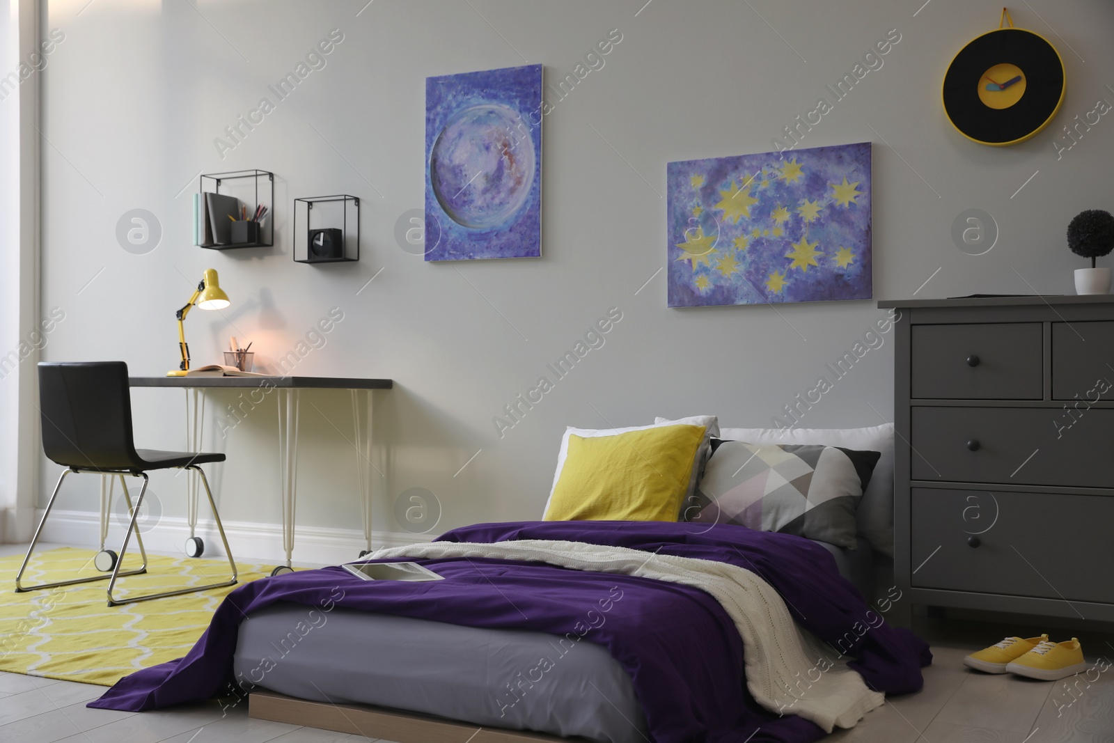 Photo of Modern teenager's room interior with comfortable bed, workplace and stylish design elements