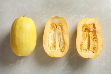 Photo of Flat lay composition with whole and cut spaghetti squash on gray background