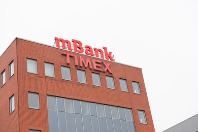 Photo of Warsaw, Poland - September 10, 2022: Building with modern Mbank and Timex logos