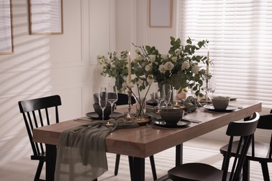 Photo of Festive table setting with beautiful tableware and decor indoors