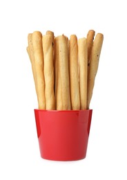 Delicious grissini sticks in cup on white background