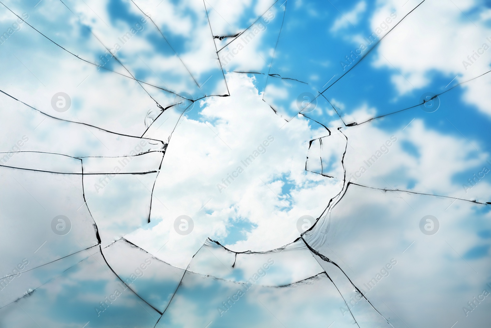 Image of View through broken window on cloudy sky