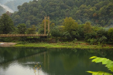 Rusty metal bridge over river in mountains