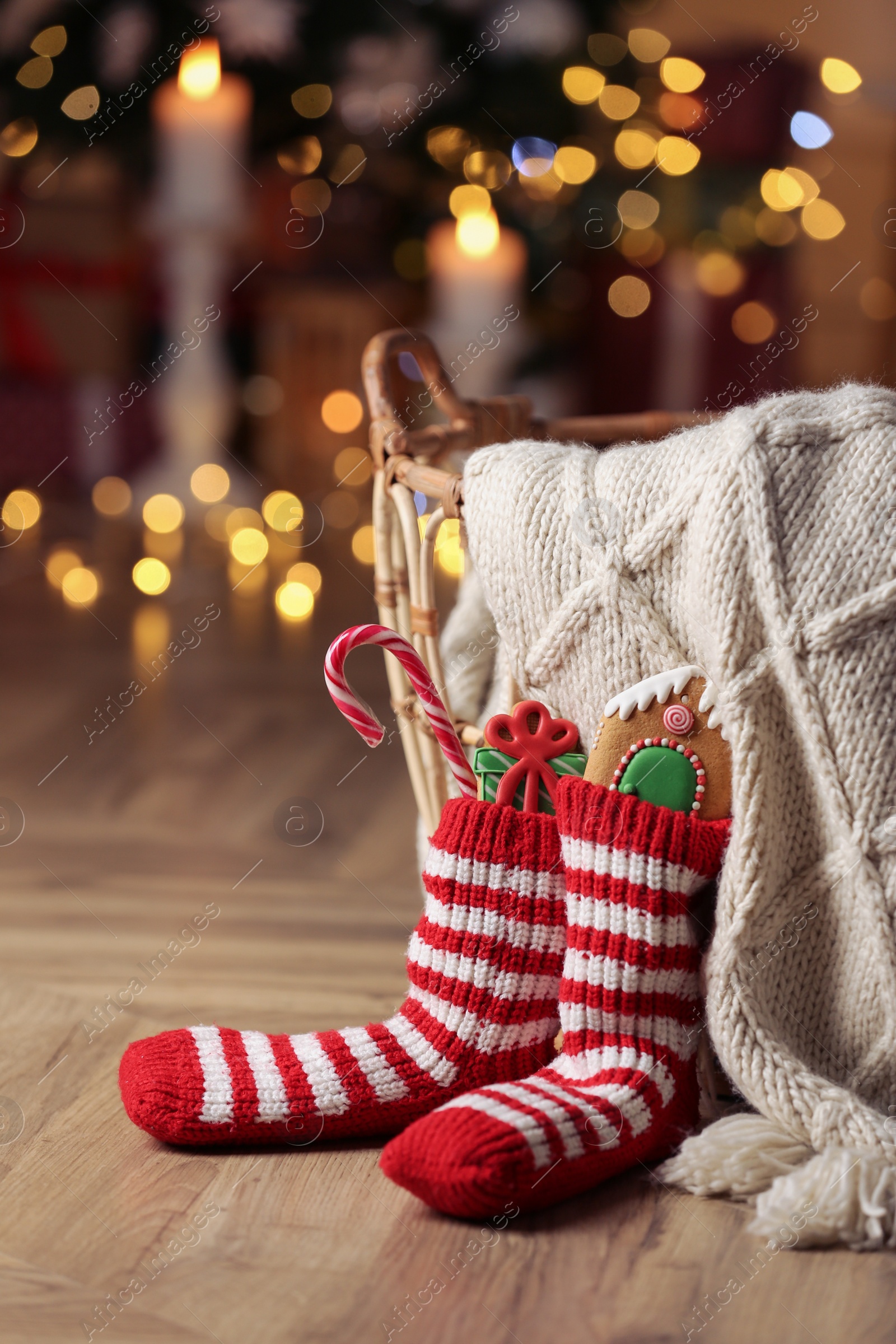 Photo of Socks filled with sweets on floor in room. Saint Nicholas Day