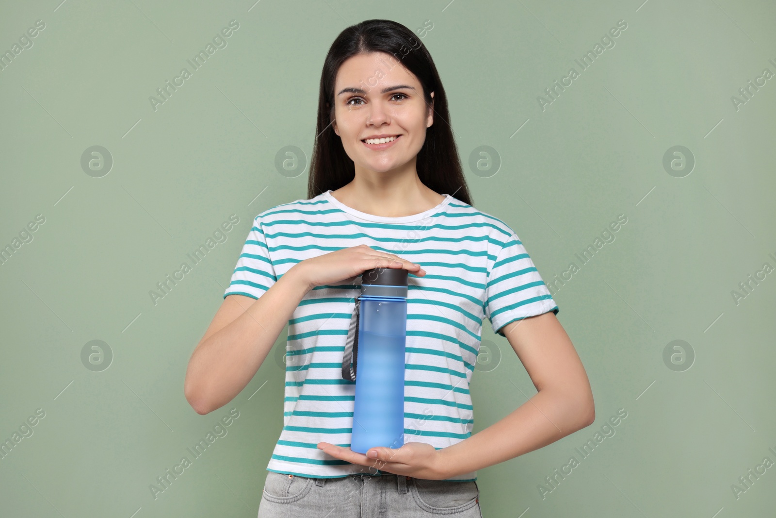 Photo of Young woman with bottle of water on green background