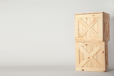 Photo of Wooden crates on light background, space for text. Shipping containers