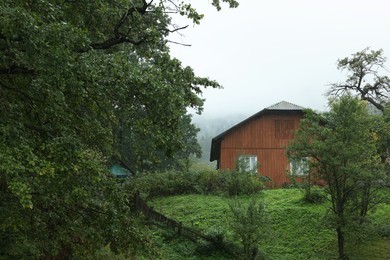 Beautiful landscape with forest and wooden house in mountains