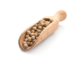 Wooden scoop with pepper grains on white background