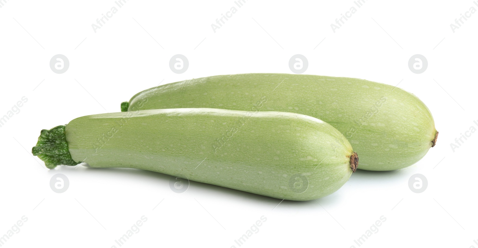 Photo of Fresh ripe green zucchinis isolated on white