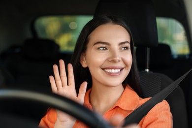 Enjoying trip. Happy young woman driving her car, view through windshield